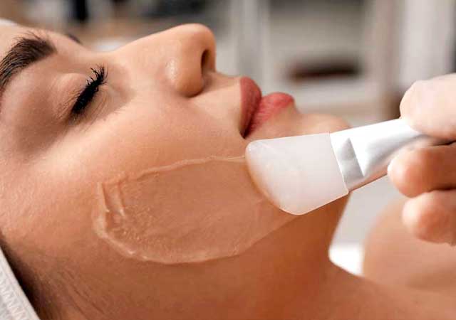 Woman getting chemical peel facial
