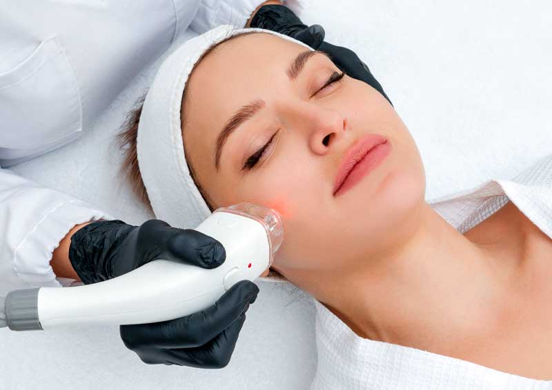 Woman getting laser skin treatment